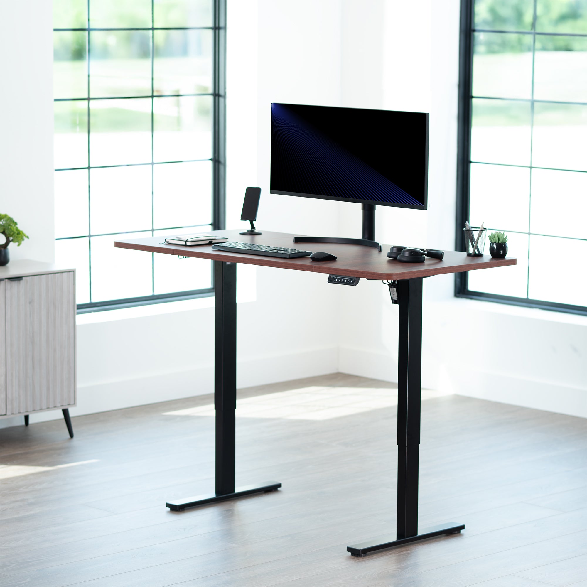 Sturdy ergonomic sit or stand active desk workstation with adjustable height using smart control panel.