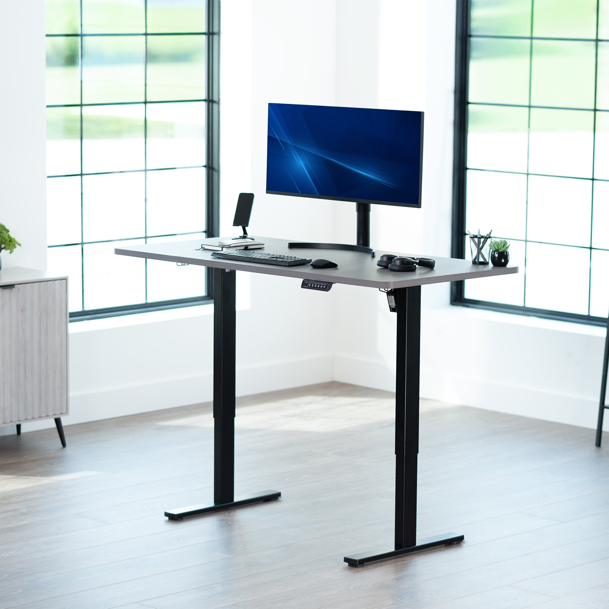Sturdy ergonomic sit or stand active desk workstation with adjustable height using smart control panel.