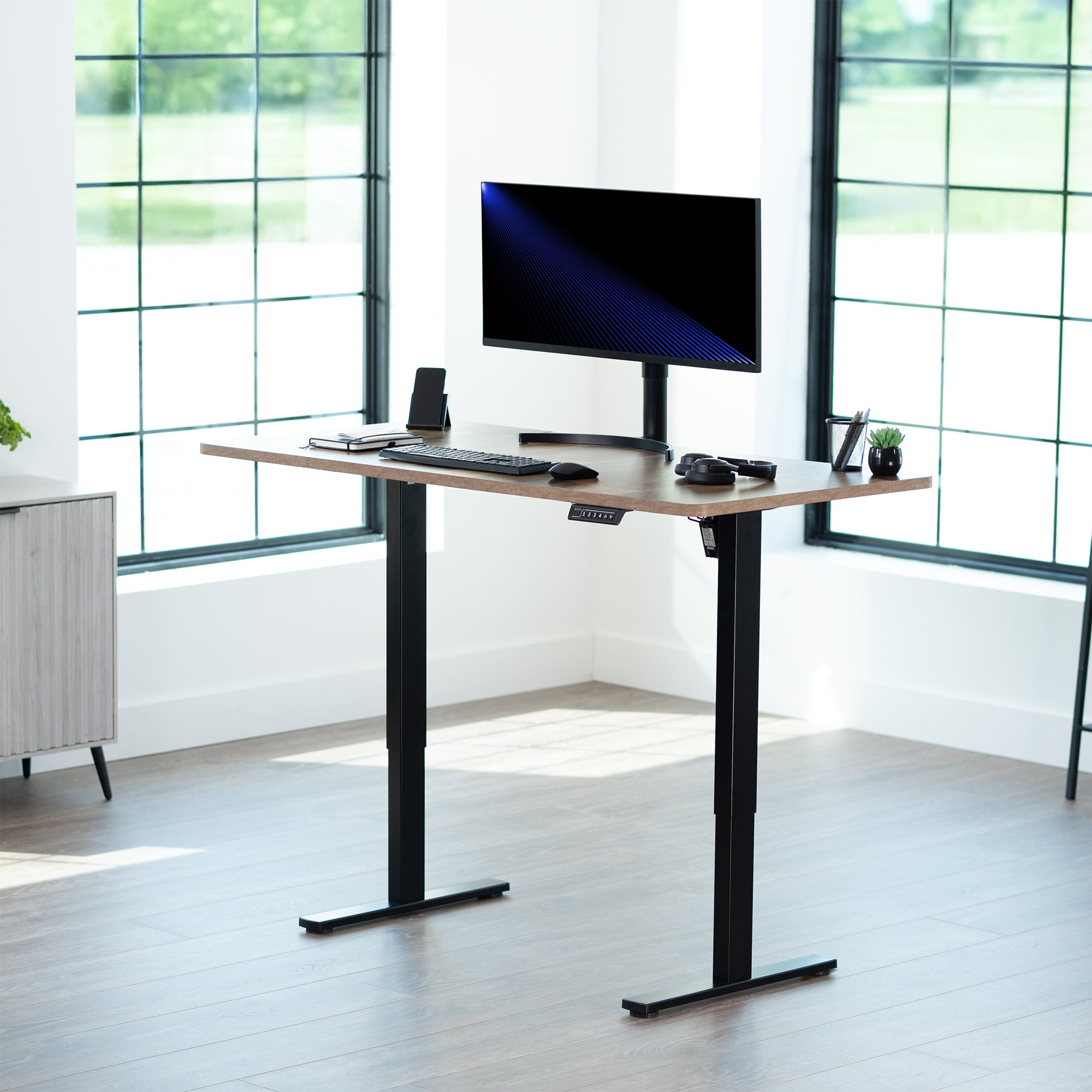 Sturdy ergonomic sit or stand active desk workstation with adjustable height using smart control panel.