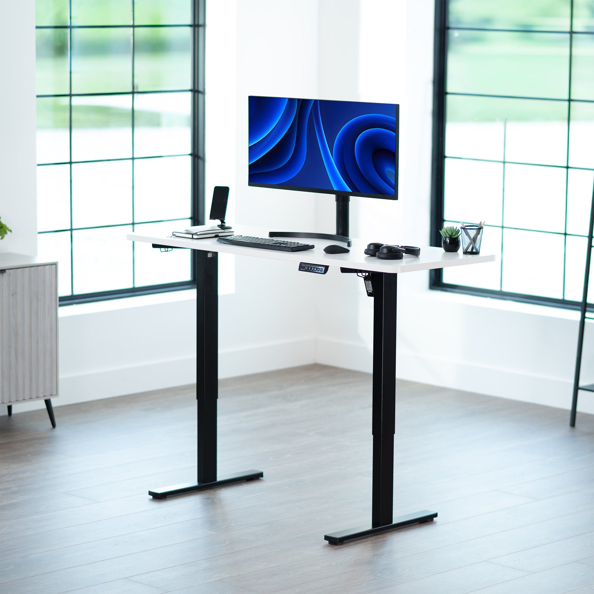 Sturdy ergonomic sit or stand active desk workstation with adjustable height using smart control panel.