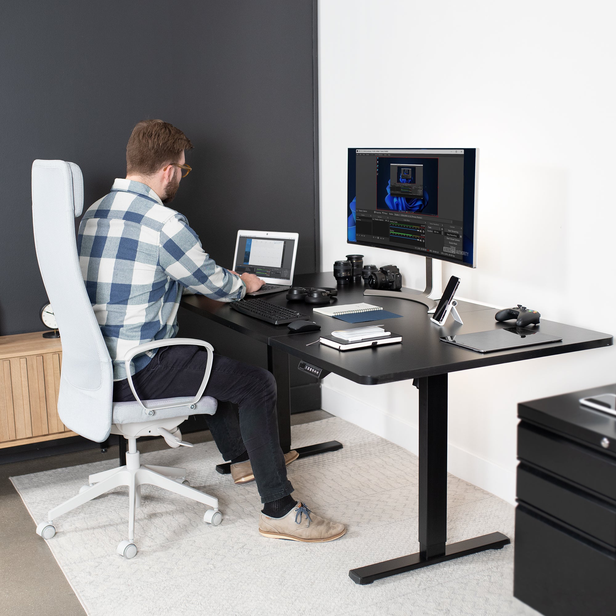 Elevated electric desk in an active workspace.