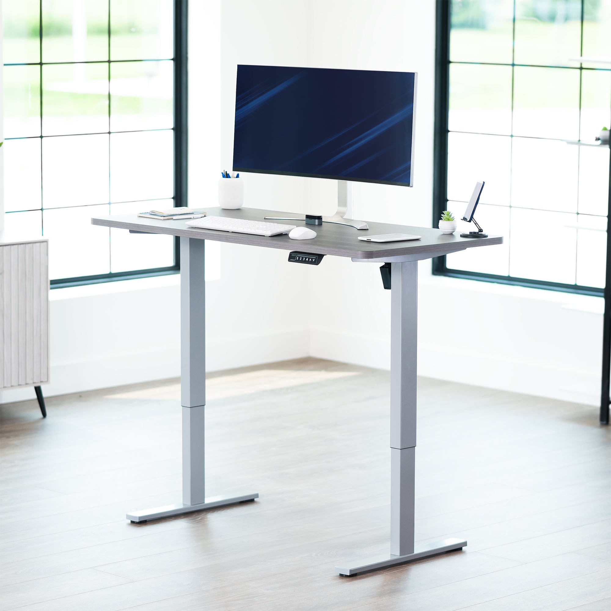 Sturdy ergonomic sit or stand active desk workstation with adjustable height using smart control panel.