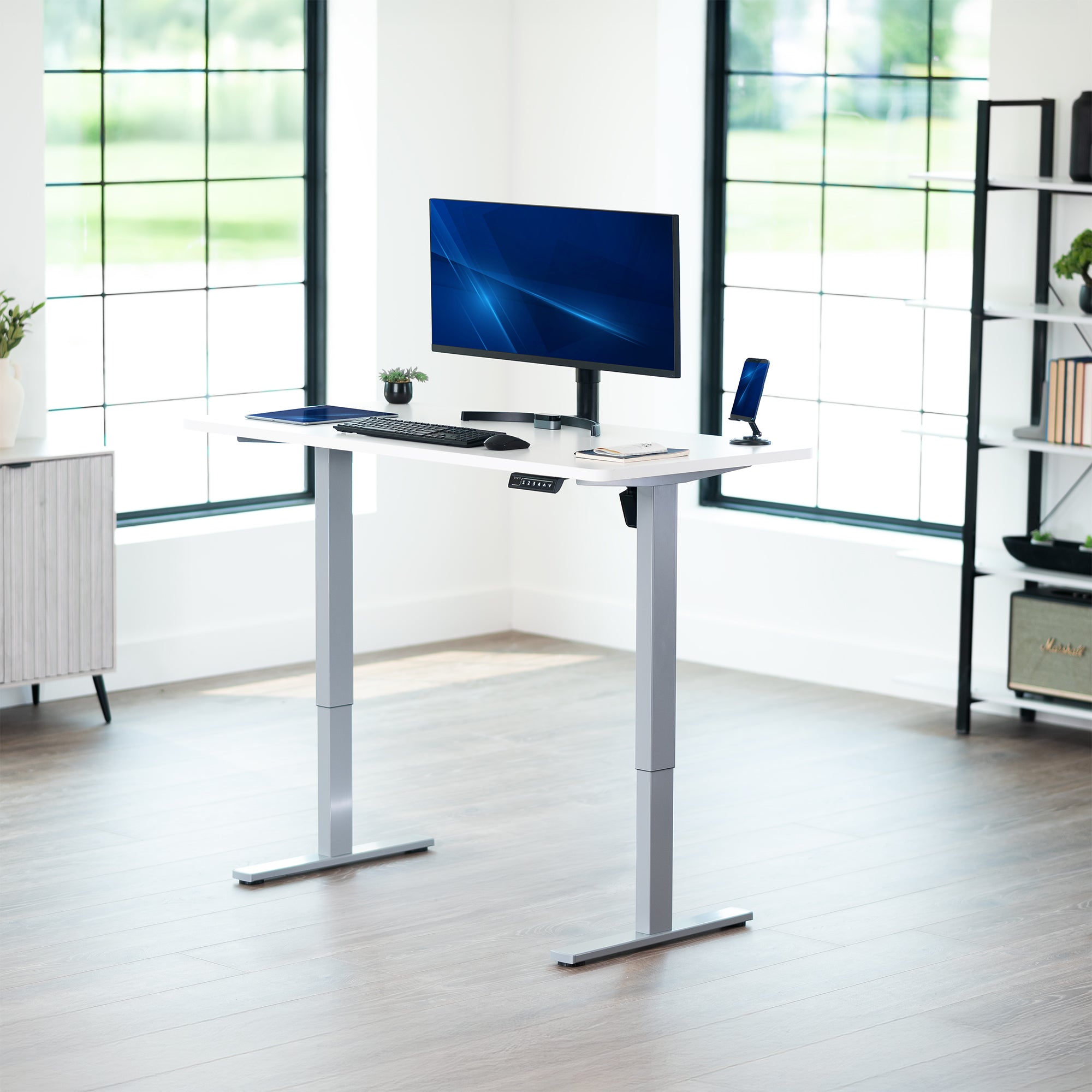 Sturdy ergonomic sit or stand active desk workstation with adjustable height using smart control panel.