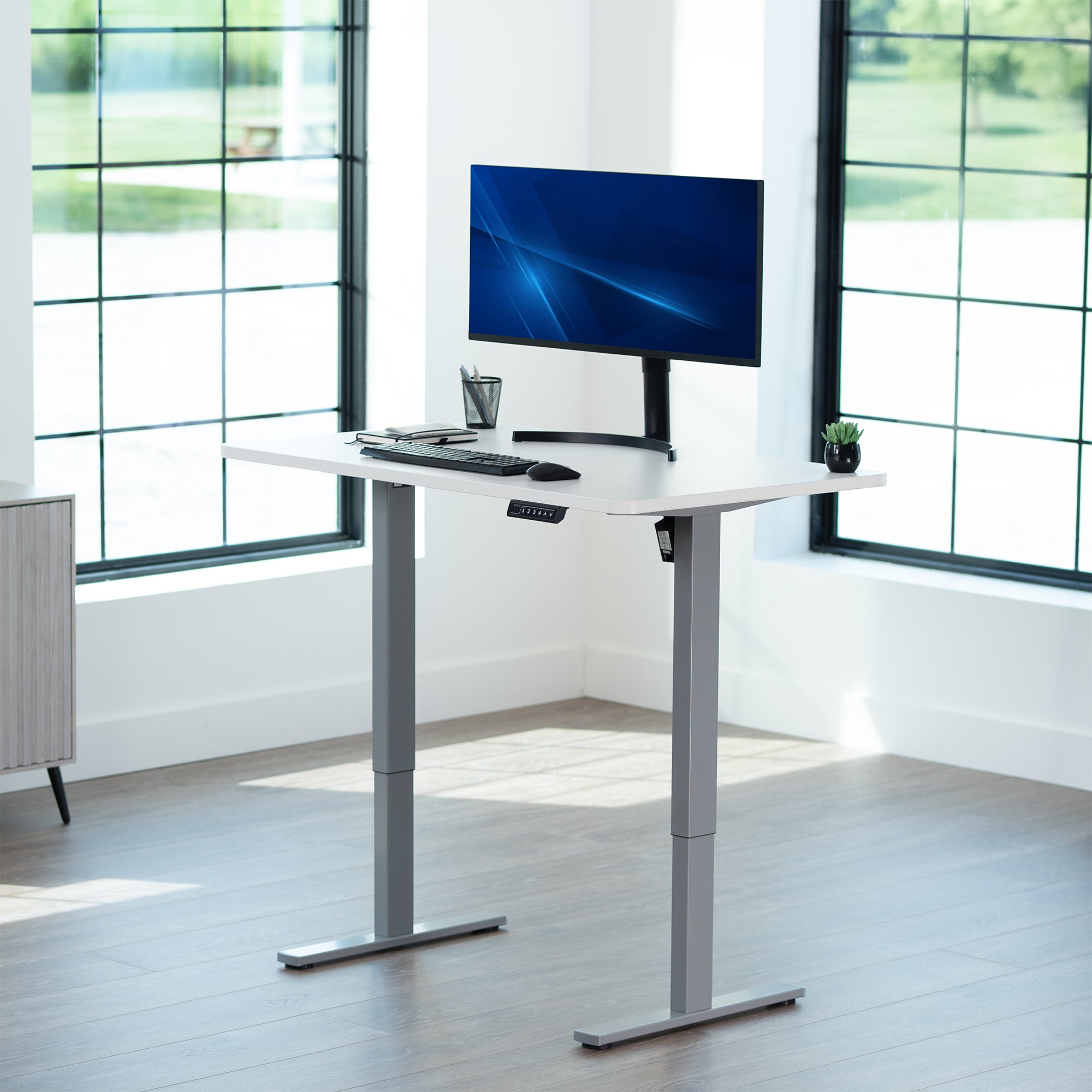 Sturdy ergonomic sit or stand active desk workstation with adjustable height using smart control panel.