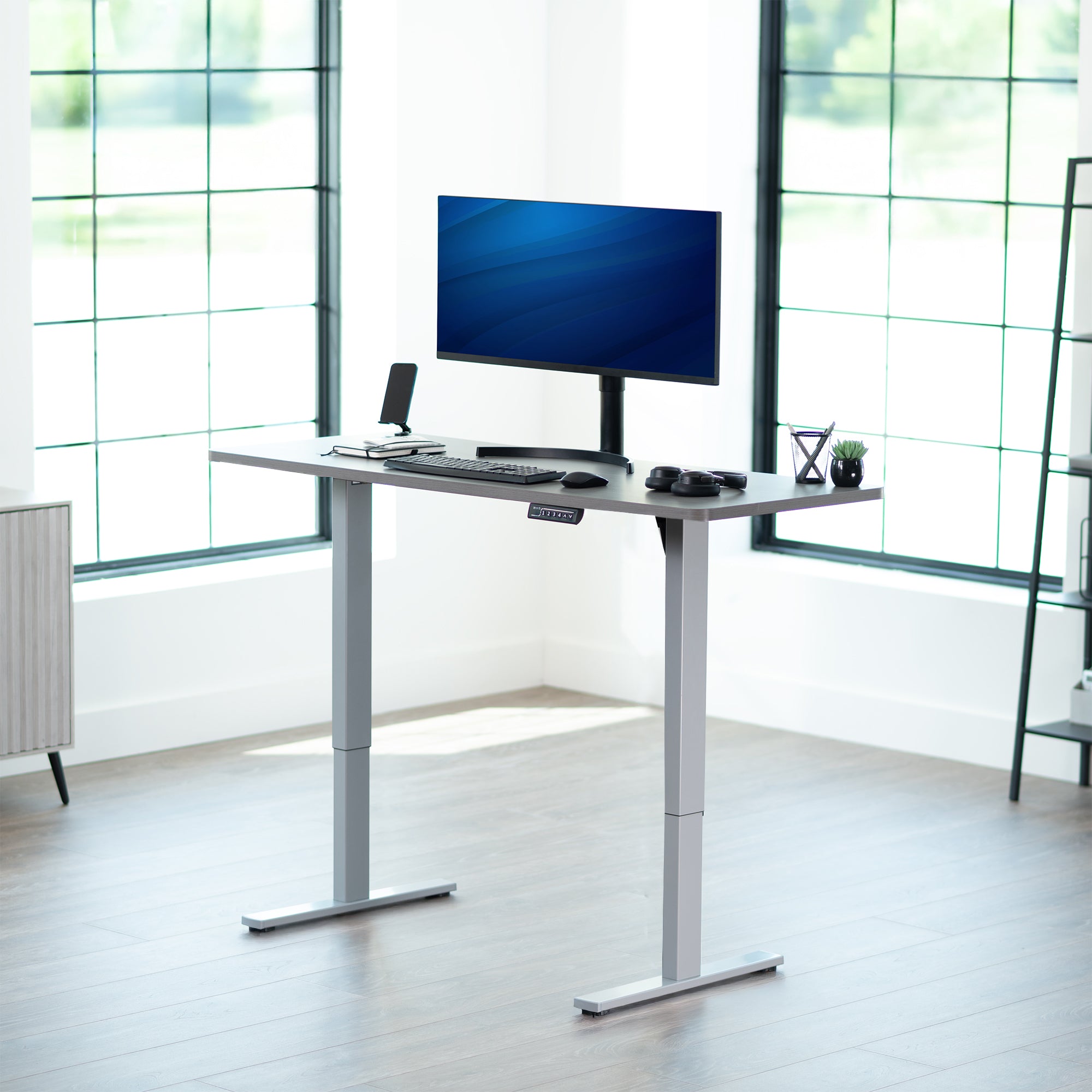 Sturdy ergonomic sit or stand active desk workstation with adjustable height using smart control panel.