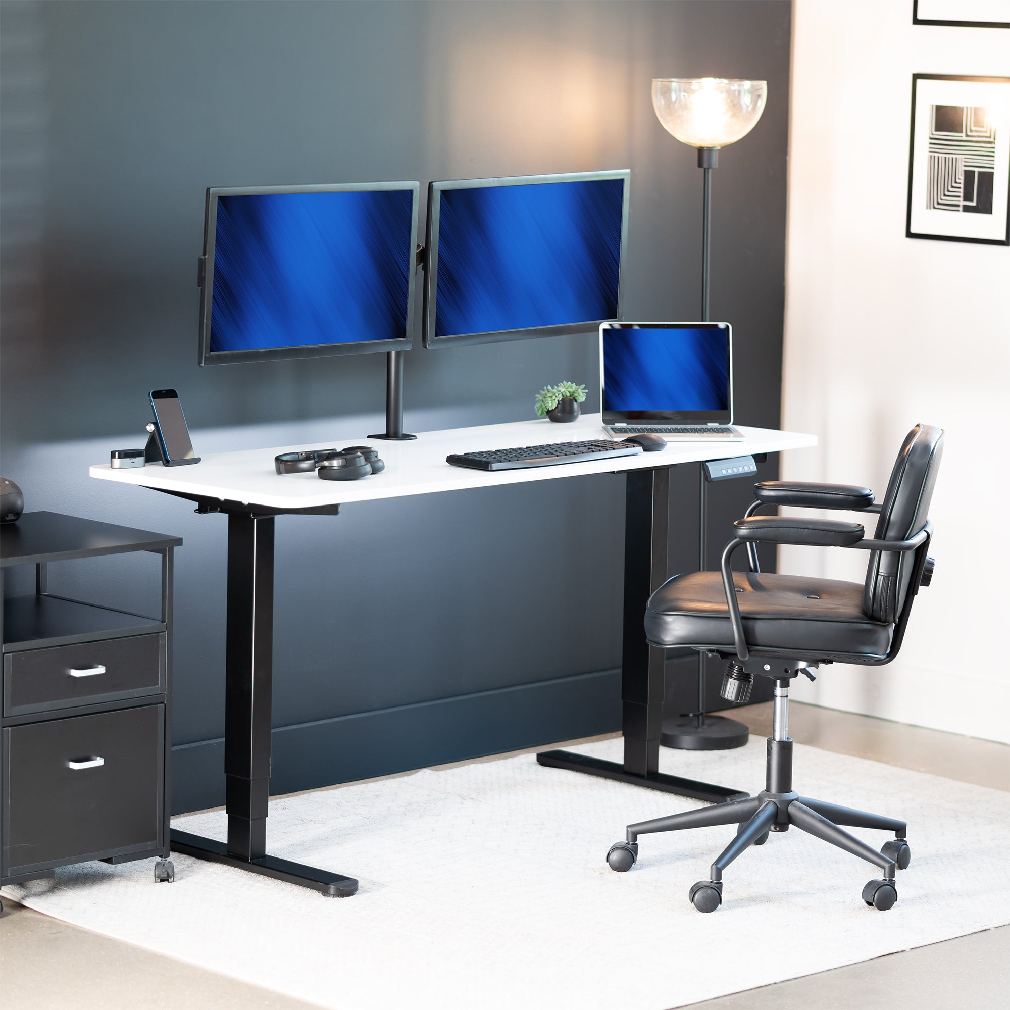 Modern office setup with a desk, chairs, and computer monitors.