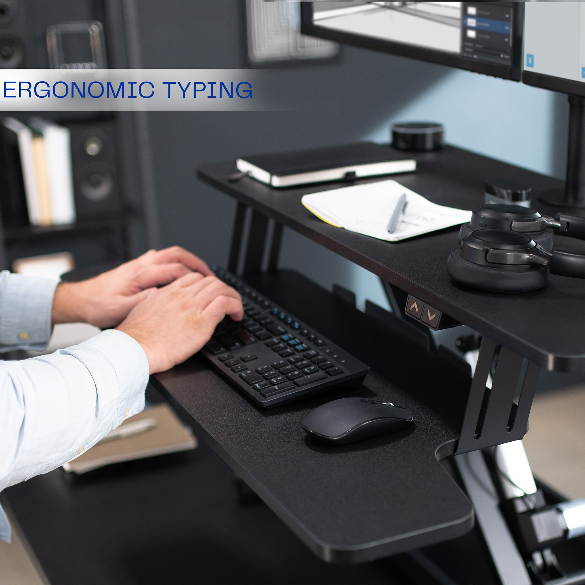 Sit to stand desk riser and dual monitor mount with electric height adjustment.