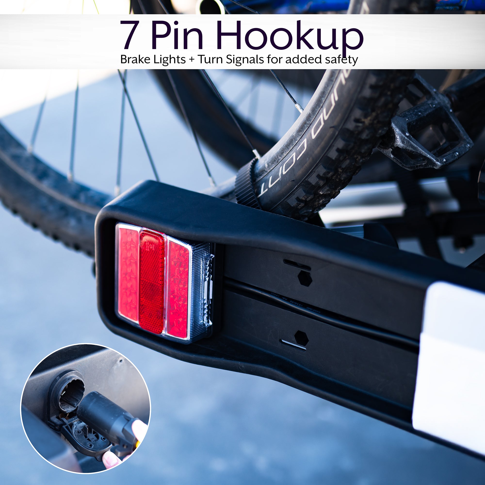 A black hitch bike rack with taillights and a license plate holder attached to the rear of a vehicle.