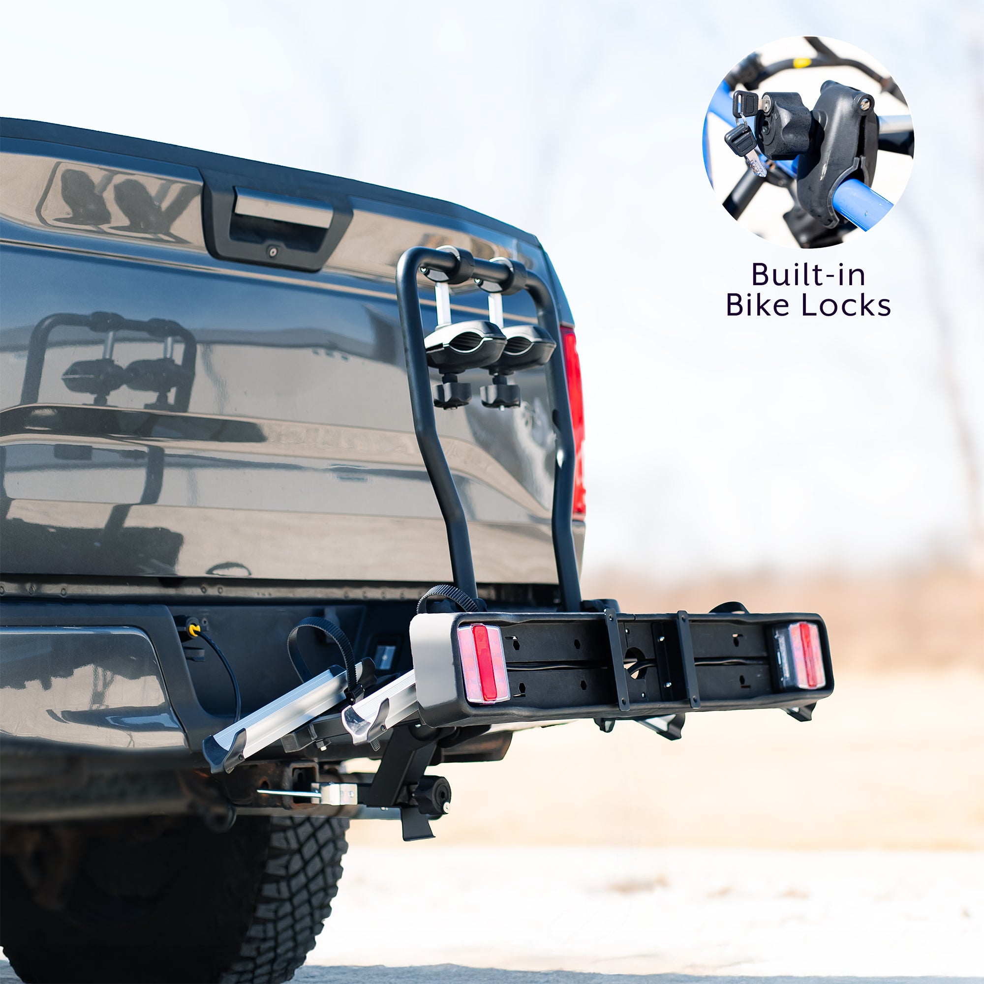 A black hitch bike rack with taillights and a license plate holder attached to the rear of a vehicle.