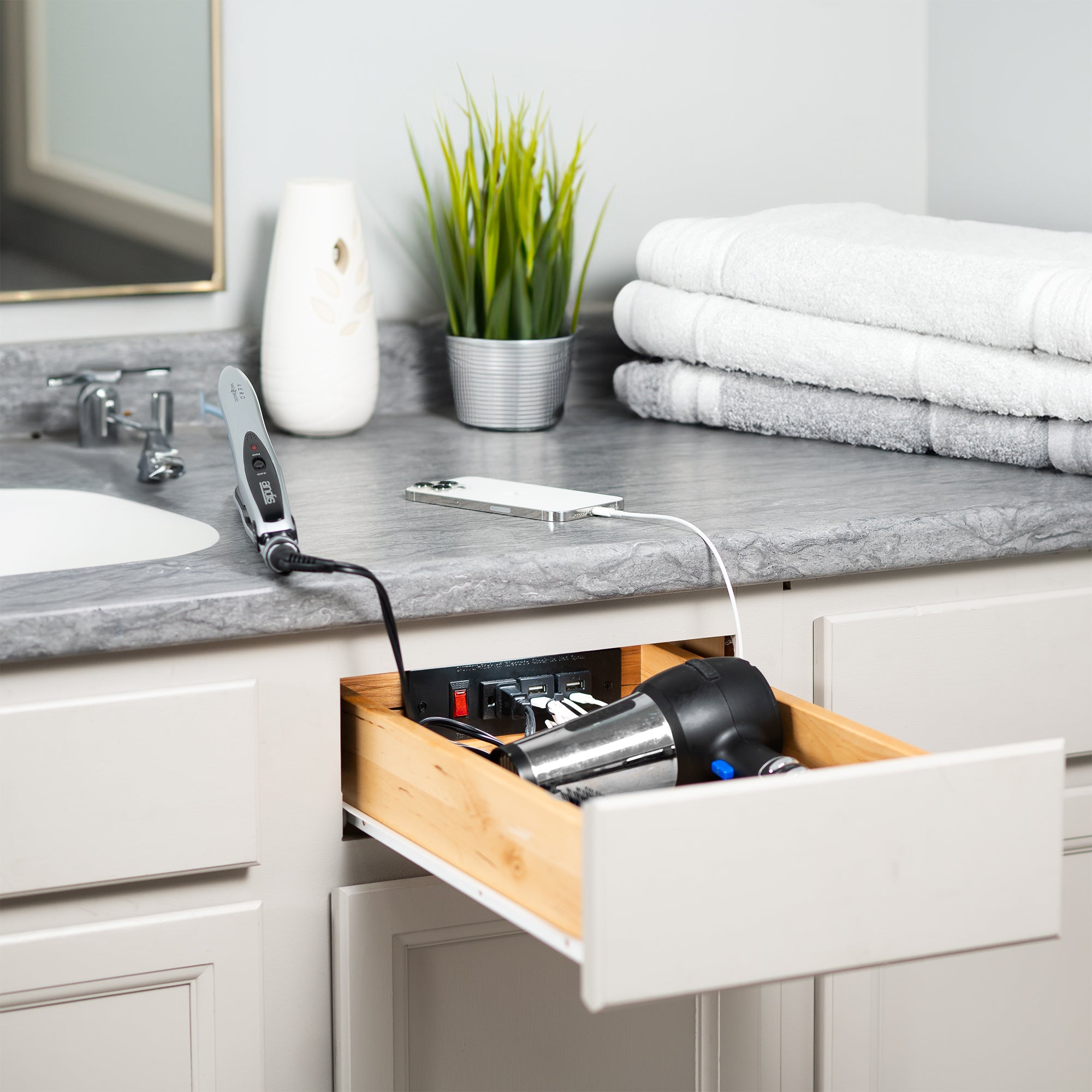 In-drawer charging station with AC outlet and USB ports.