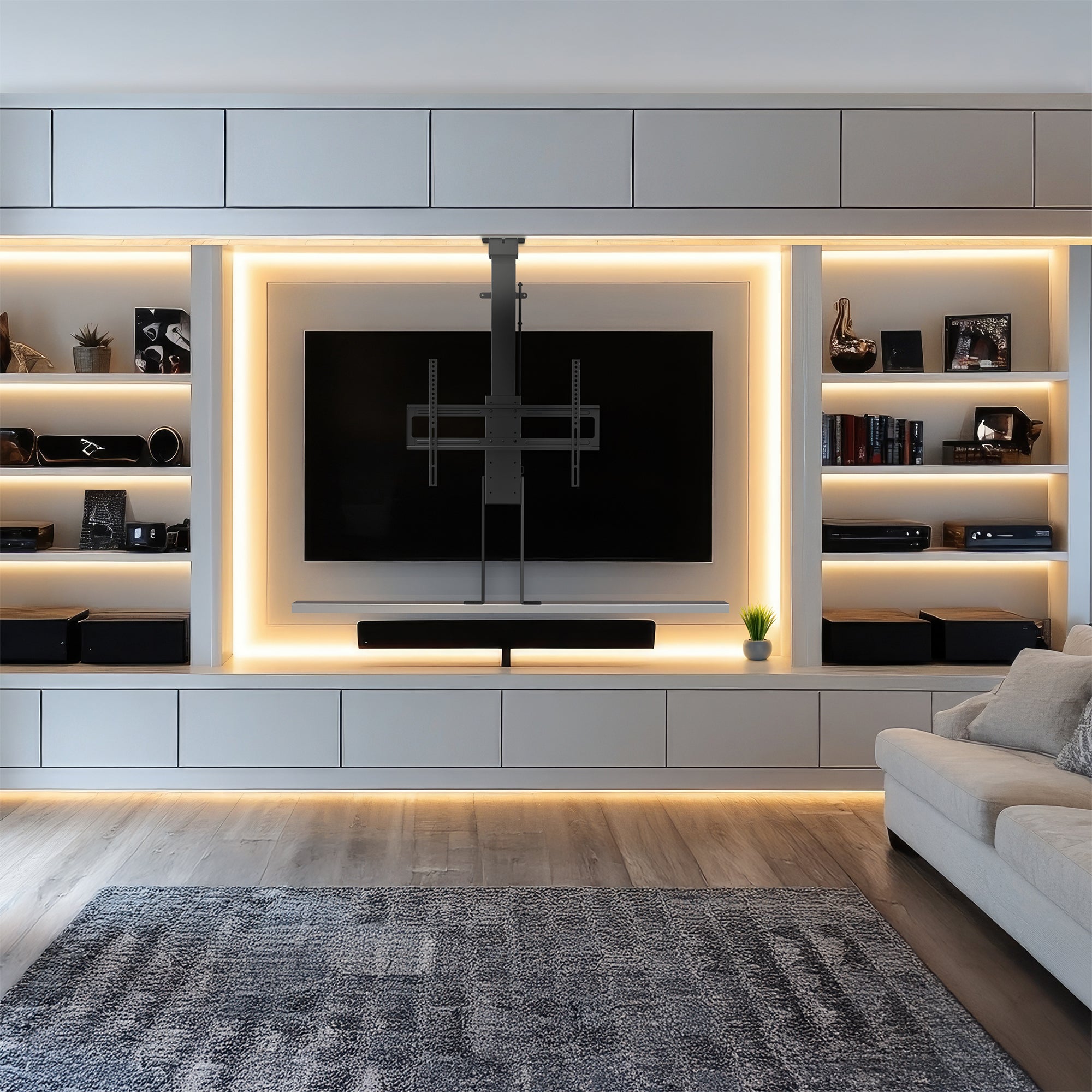 A motorized large TV mount with remote control, showing a flat panel TV attached to a ceiling mount with an extension pole.