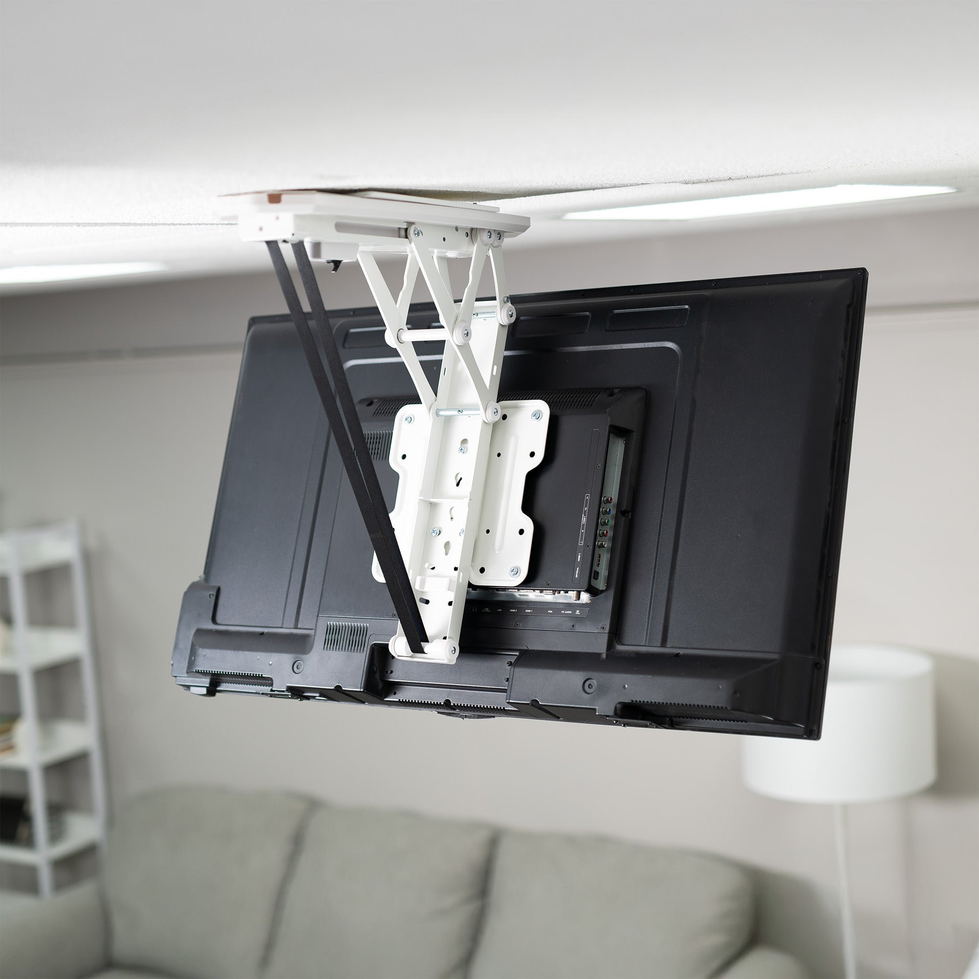 TV mounted on a ceiling bracket in a living room setting