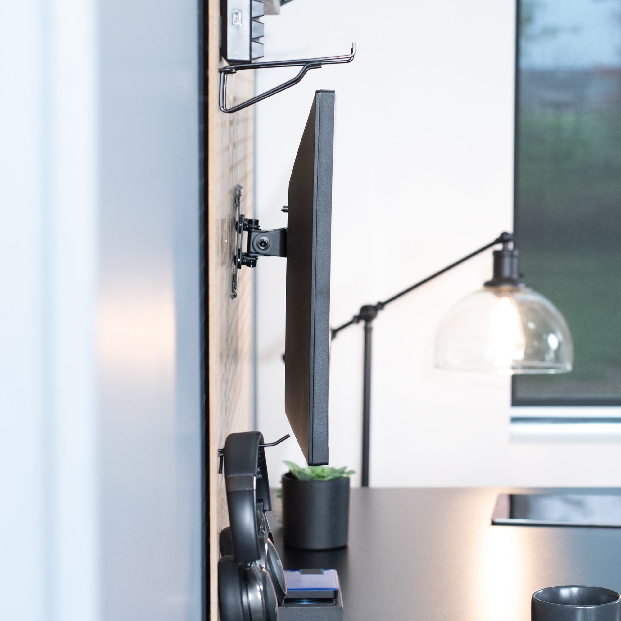 Pegboard mounted single monitor mount with tilt, swivel, and rotation.