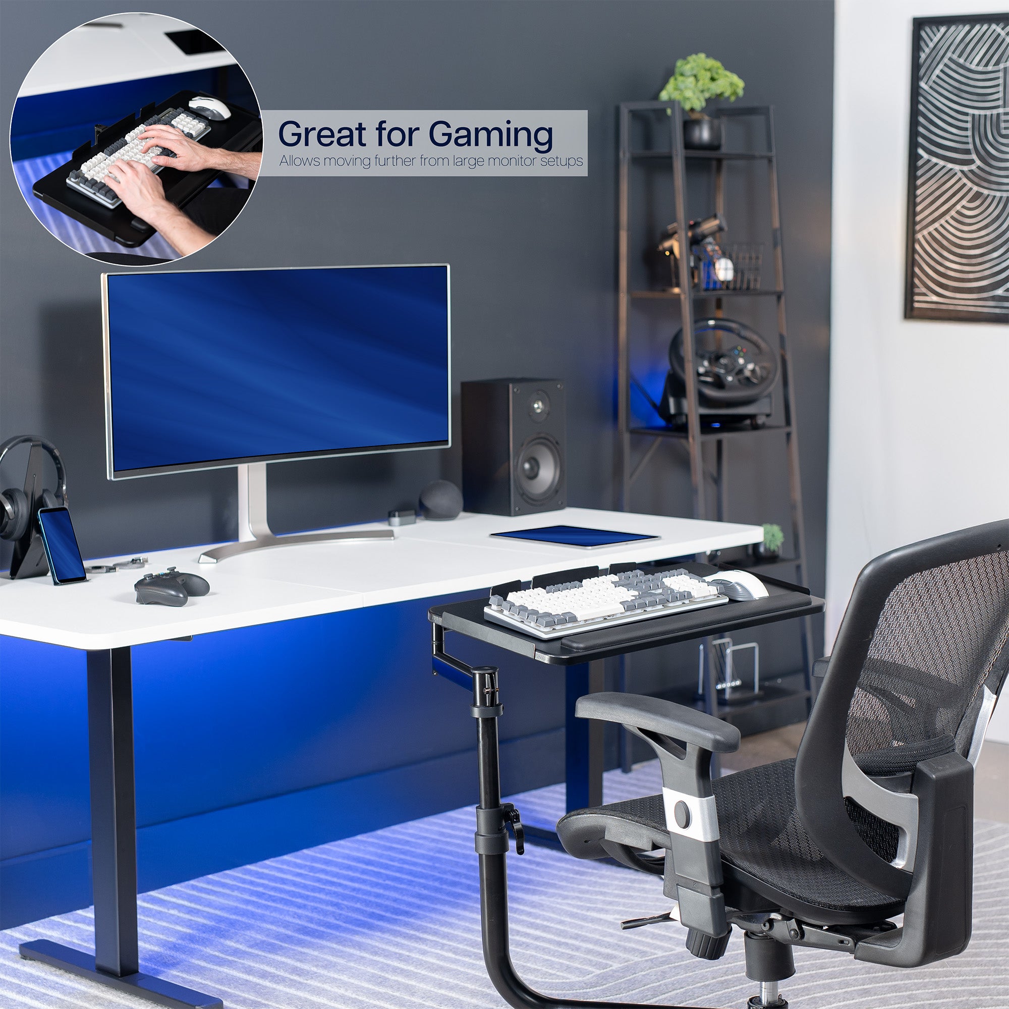 Gaming desk setup with computer monitor, keyboard, mouse, and chair in a room.