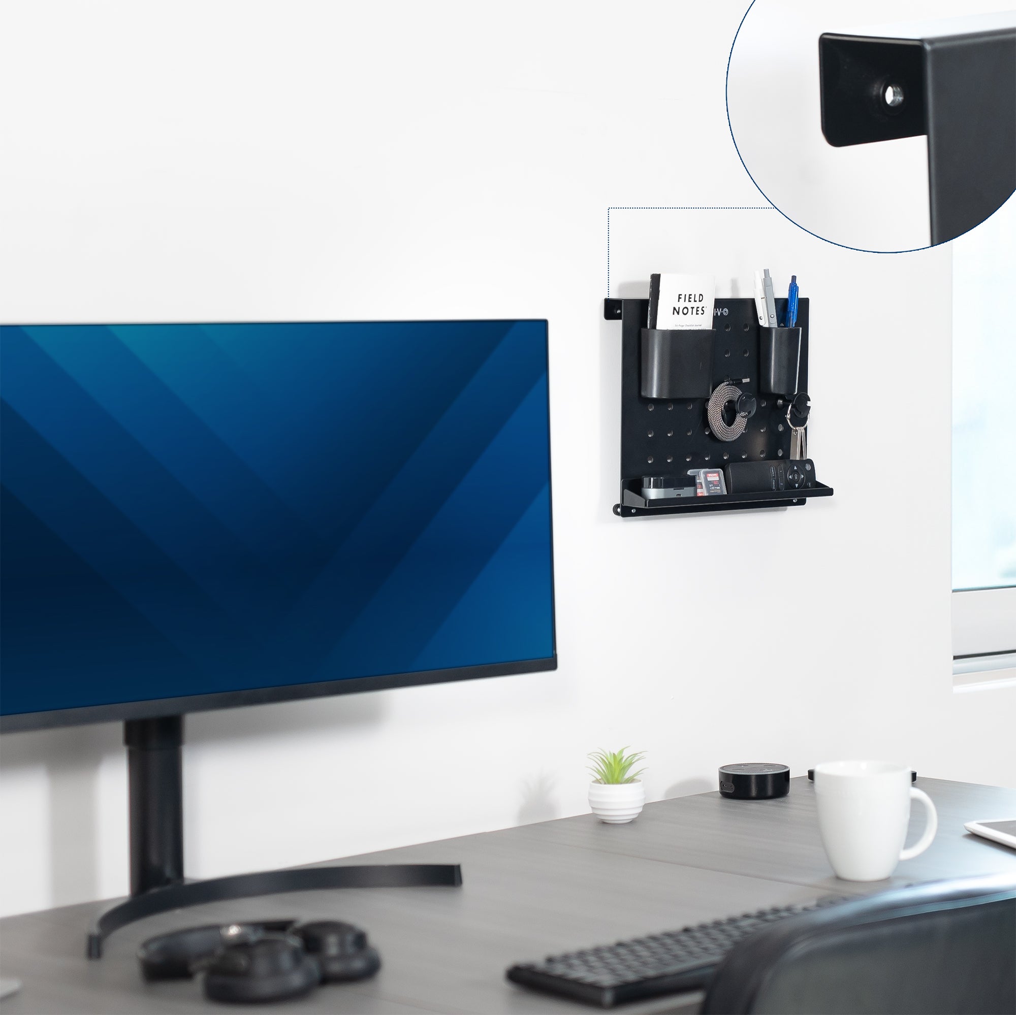 A black pegboard desk organizer with various slots and holders for office supplies and a mobile phone.