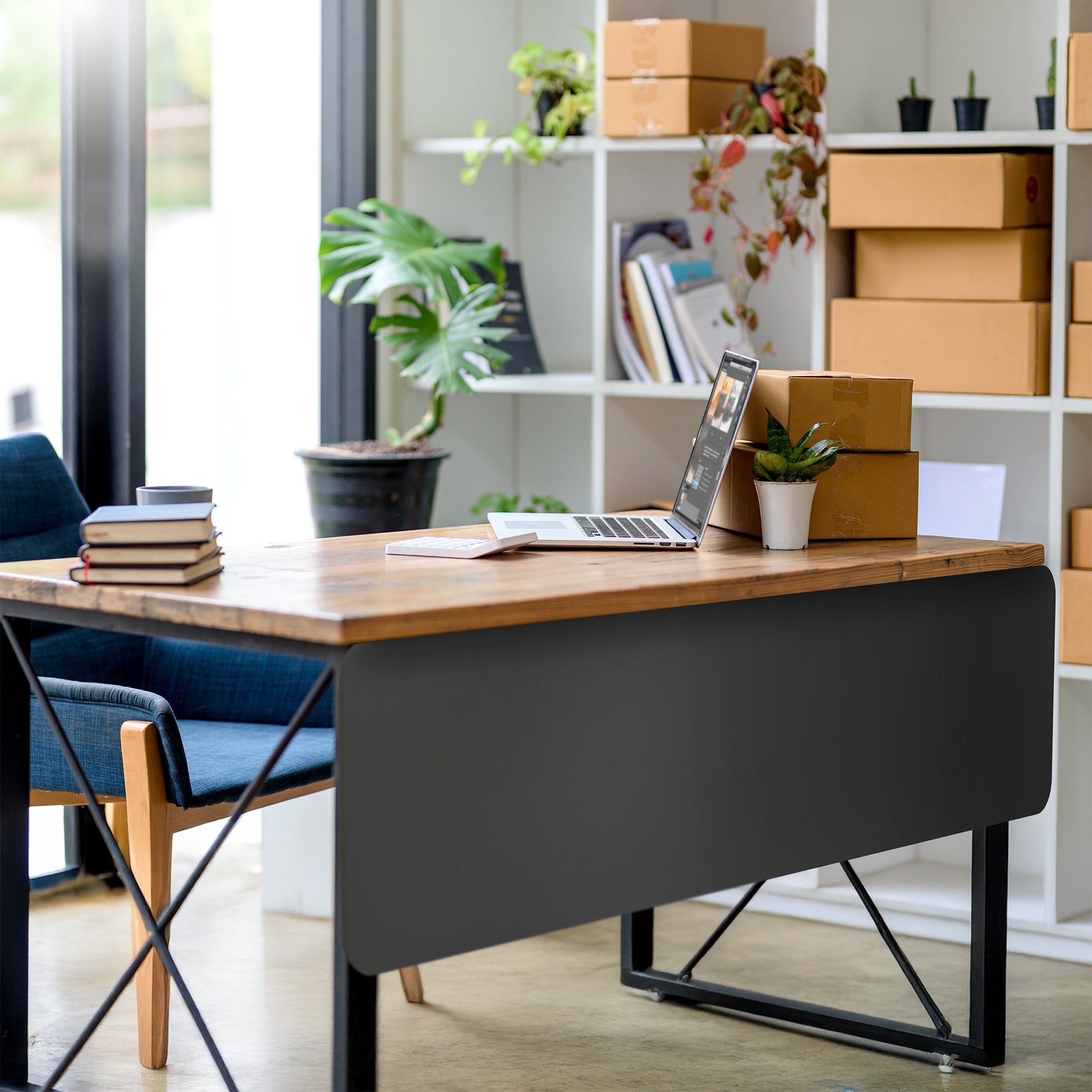 A black laminate modesty panel on a modern desk in a home office.