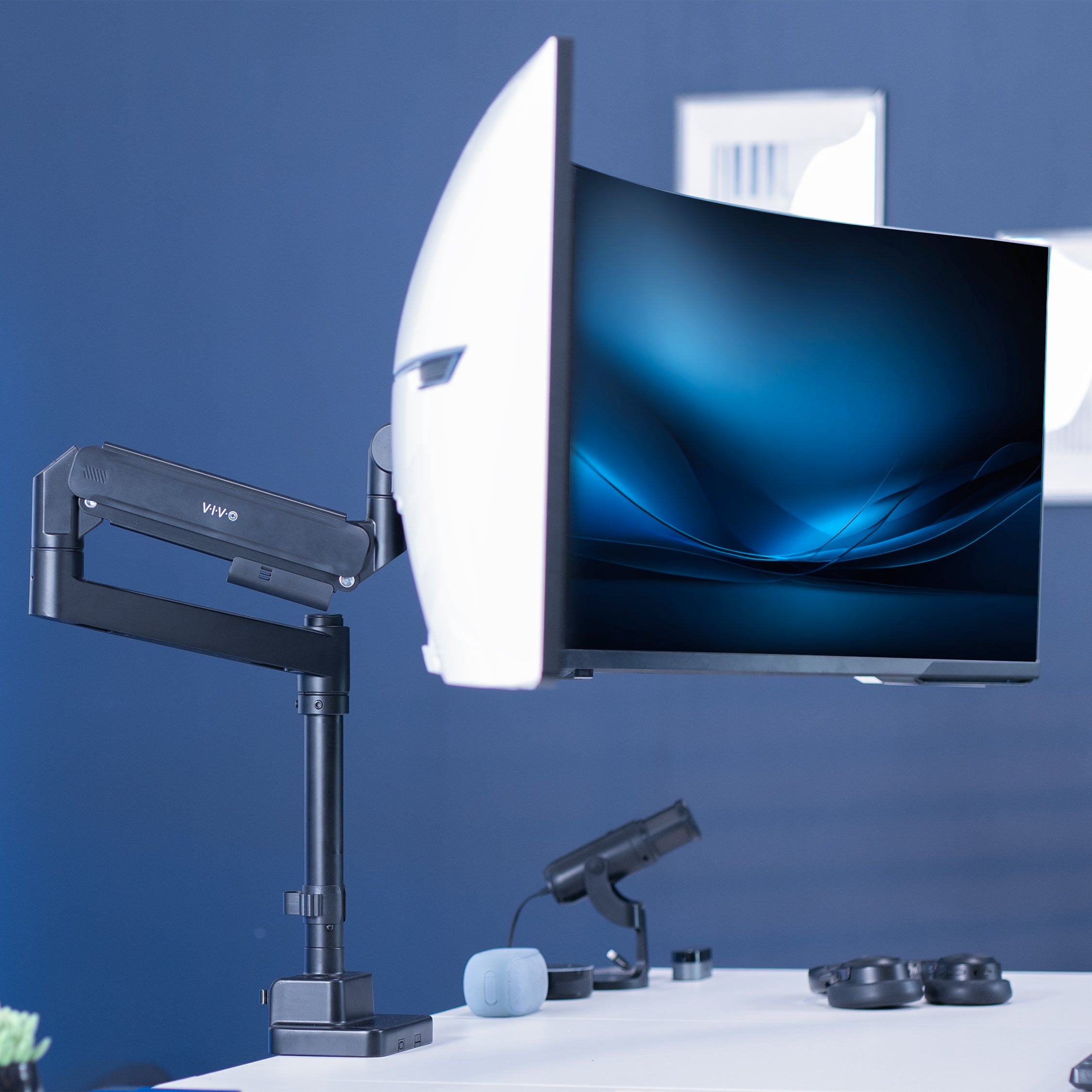 Single ultrawide monitor mounted on a pneumatic arm desk mount.