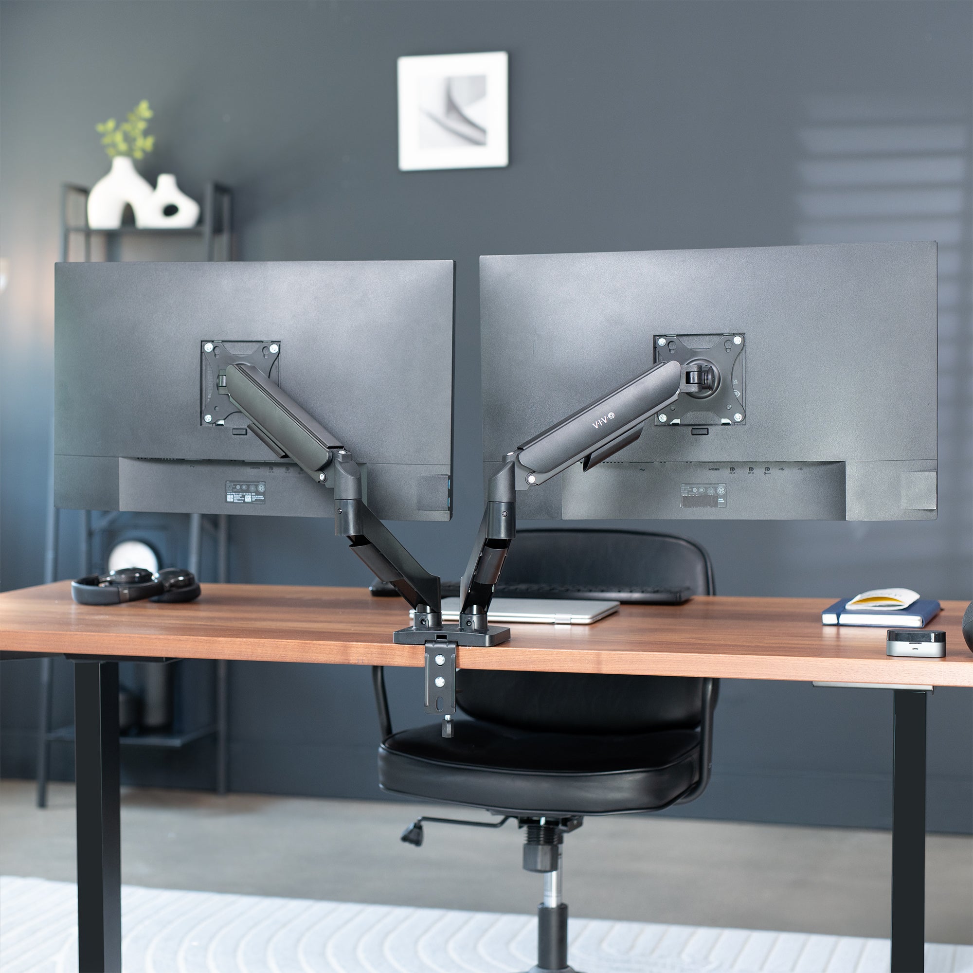 Sturdy adjustable mechanical arm dual monitor ergonomic desk stand for office workstation.