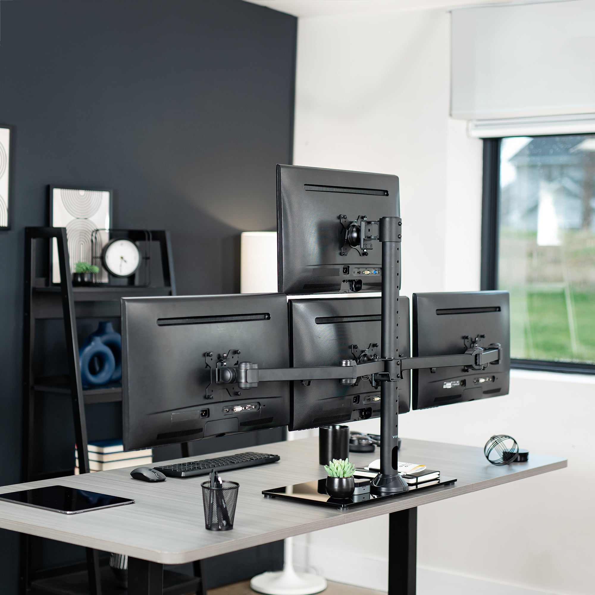 Sturdy height adjustable quad monitor desk stand.