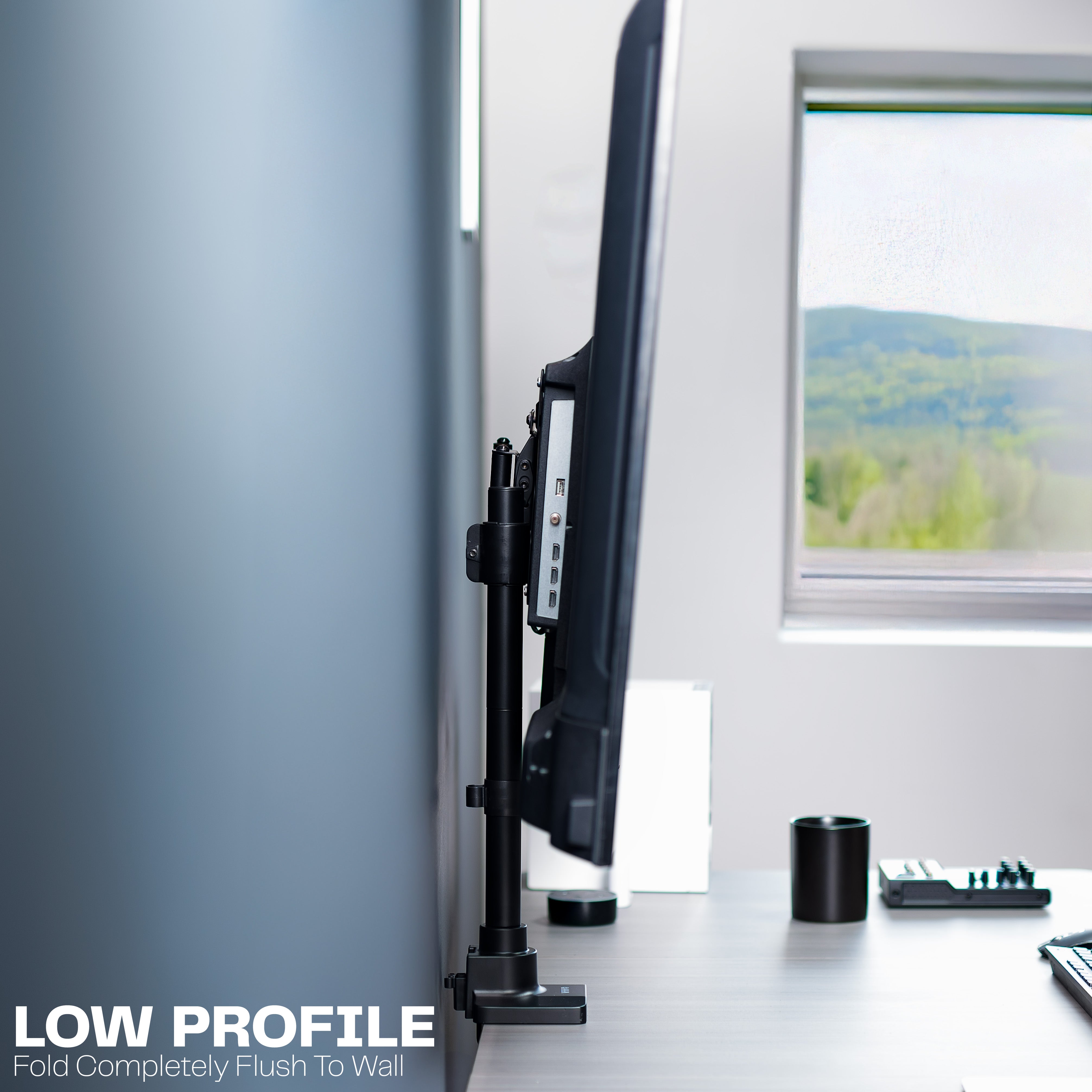 Low profile TV desk mount with articulating arm with cable management.