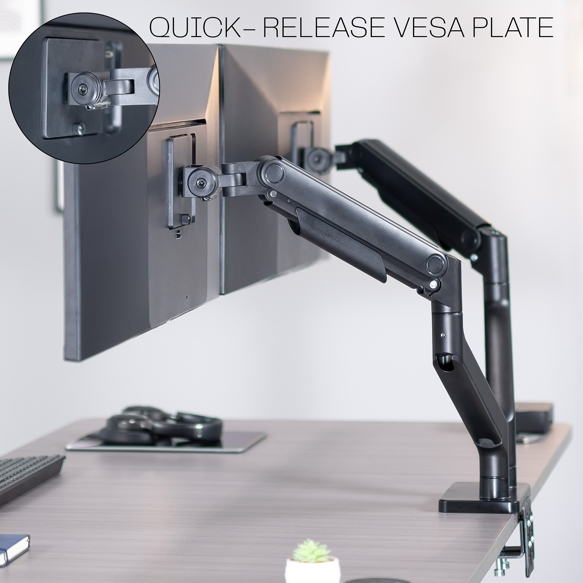 A dual monitor desk mount with pneumatic arms with text on quick release feature.