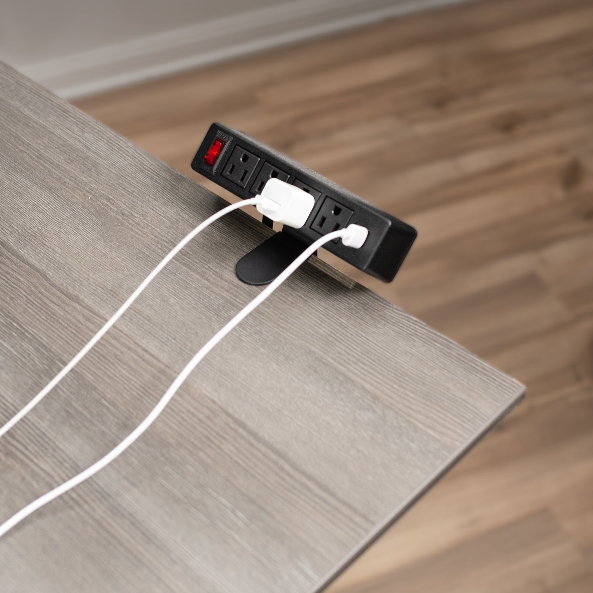 Convenient clamp on desktop power strip to elevate chargers.