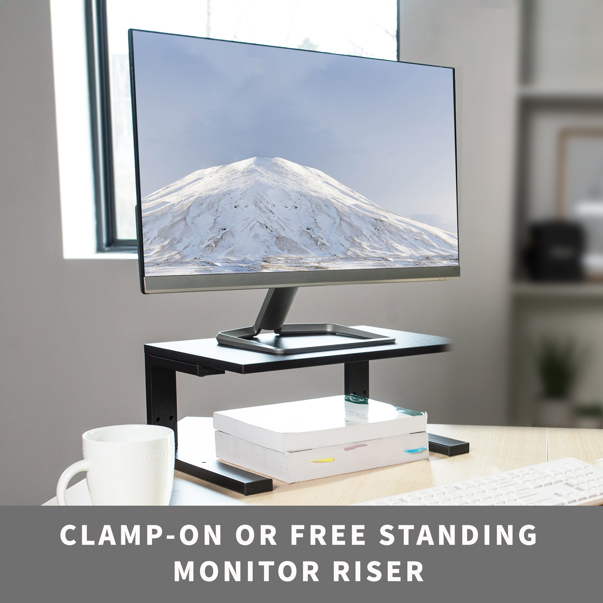 A clamp on a desk shelf is being used as a free-standing monitor riser.