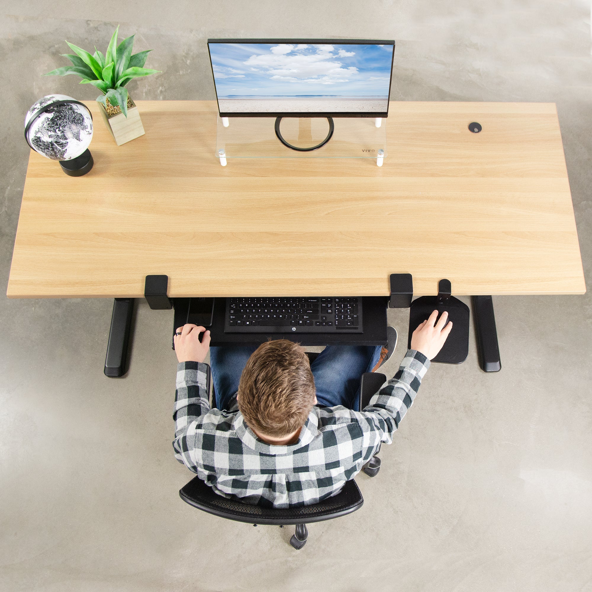 Clean, modern, and spacious desktop with under-desk keyboard and mouse pad trays.
