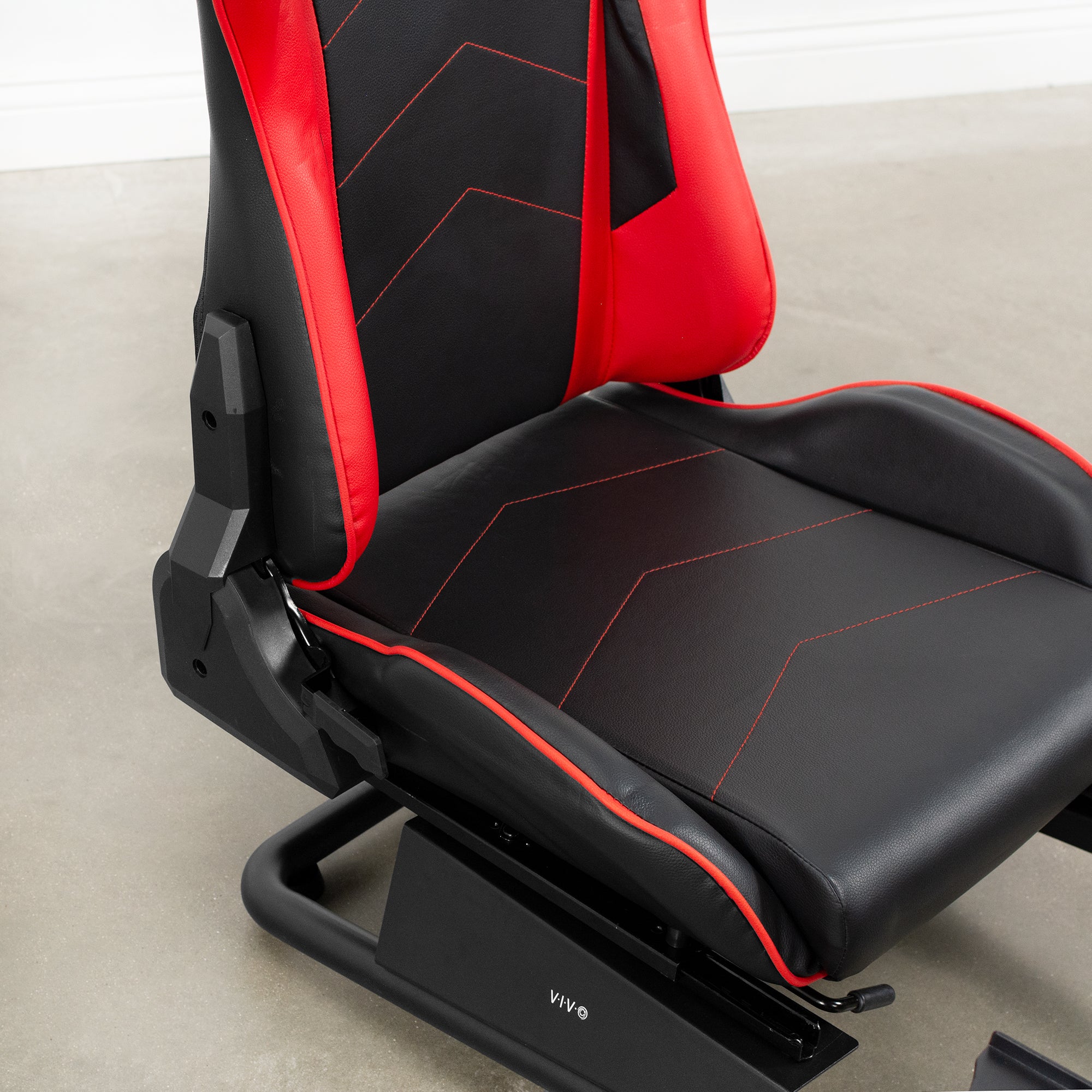 Red and black leather racing seat for gaming system set up.