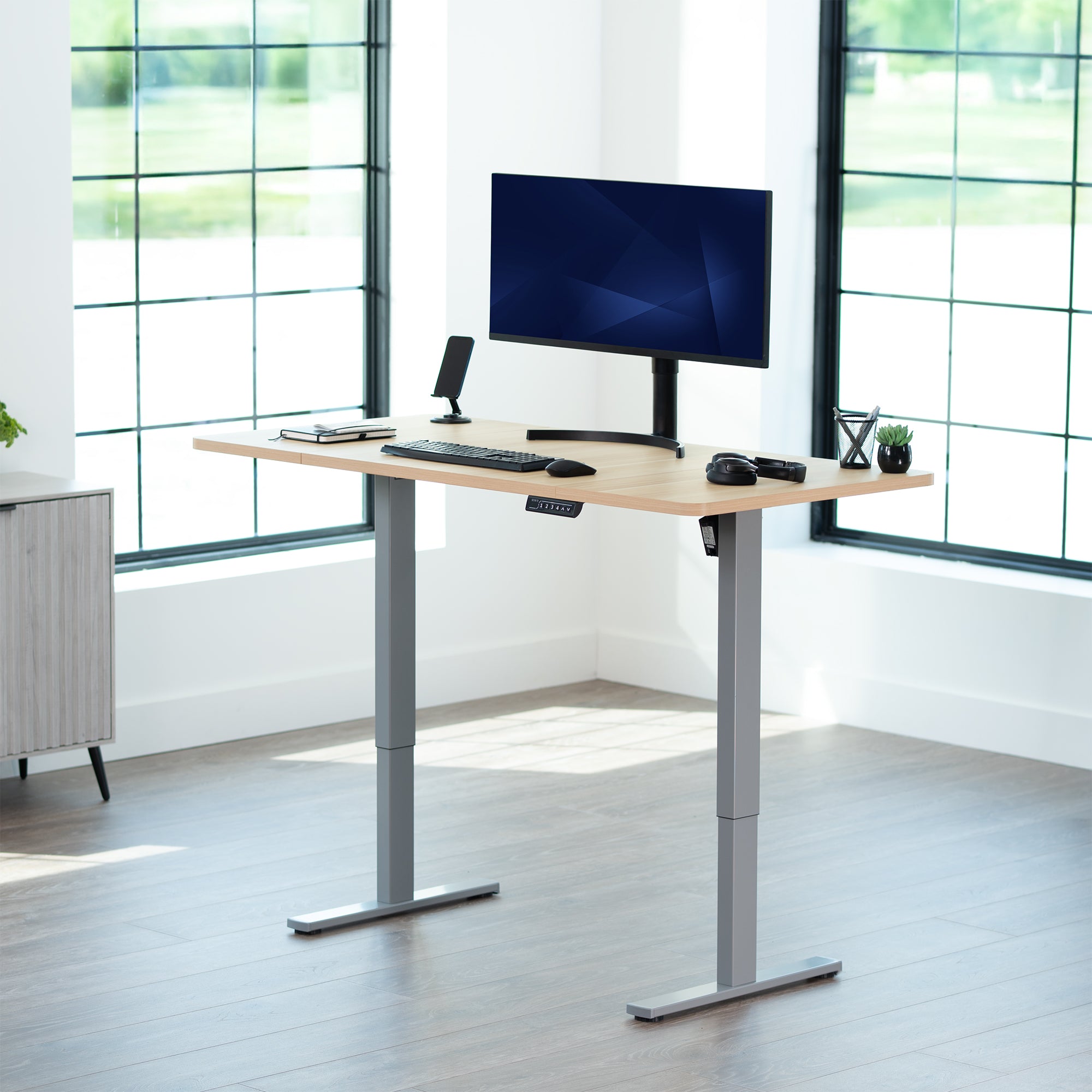 Sturdy ergonomic sit or stand active desk workstation with adjustable height using smart control panel.