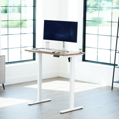 Sturdy ergonomic sit or stand active desk workstation with adjustable height using smart control panel.