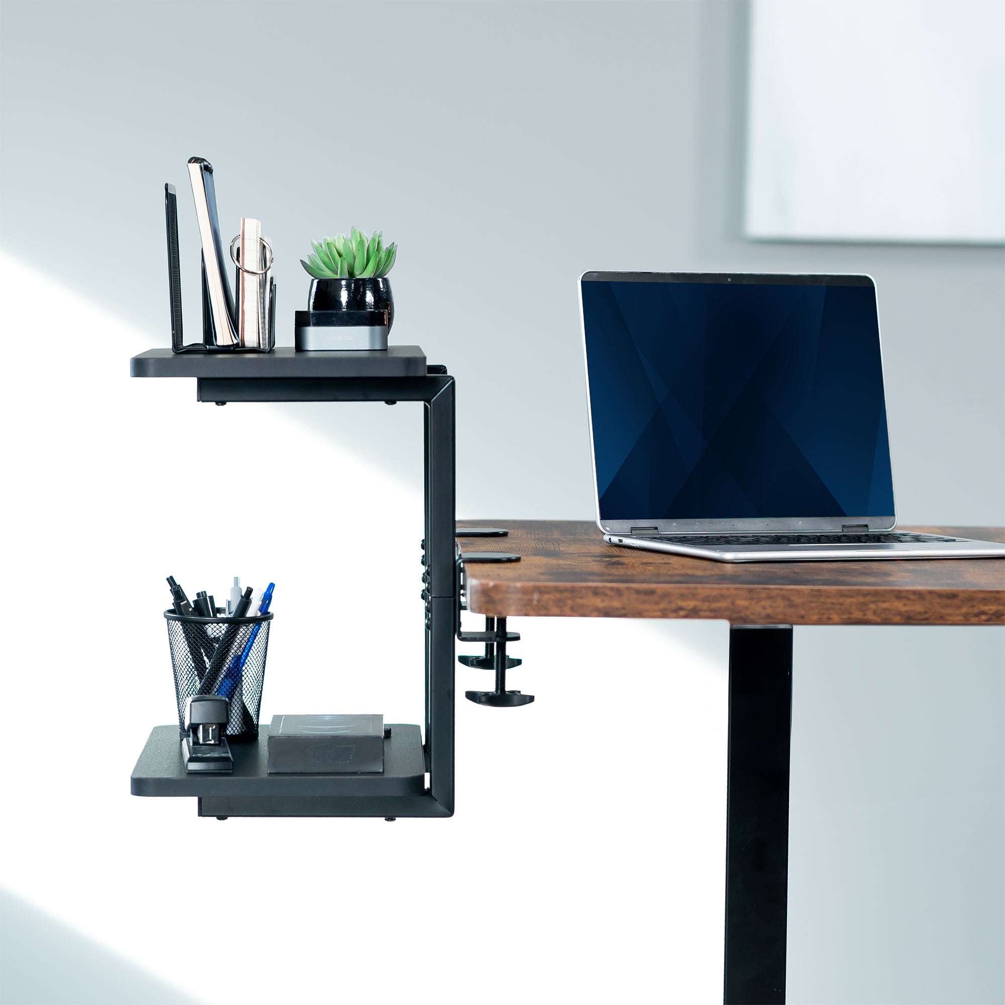 Above or below desk dual tier adjustable shelving system for flexible desk organization using convenient clamp-on storage. This versatile two-platform product can be arranged in multiple configurations to suit your workspace needs and aesthetic preferences.