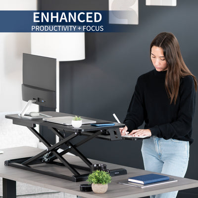 Sturdy height adjustable 2-tiered desk riser for ergonomic office workstation.