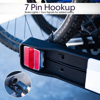 A black hitch bike rack with taillights and a license plate holder attached to the rear of a vehicle.