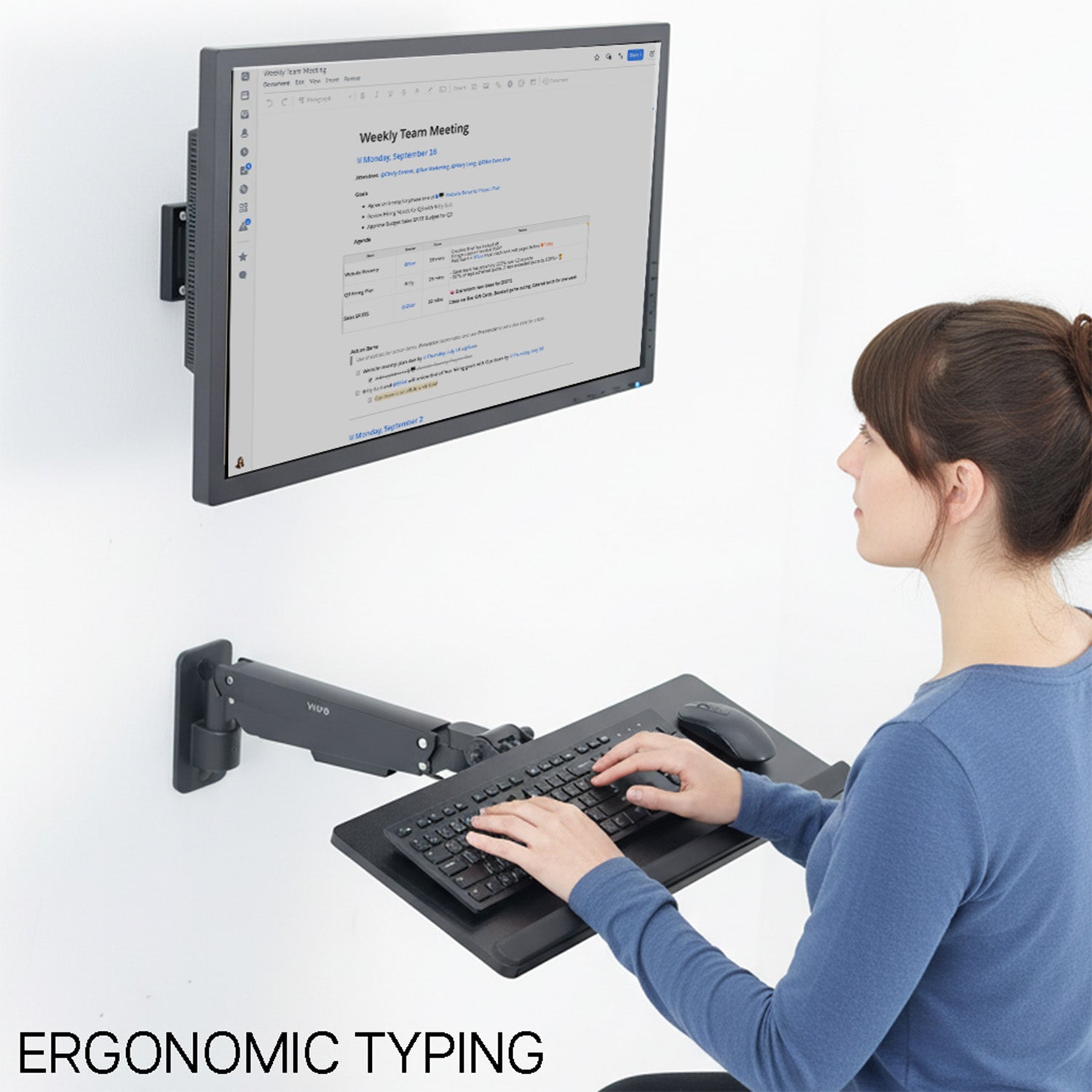 Person using a floating monitor and keyboard setup on a white background