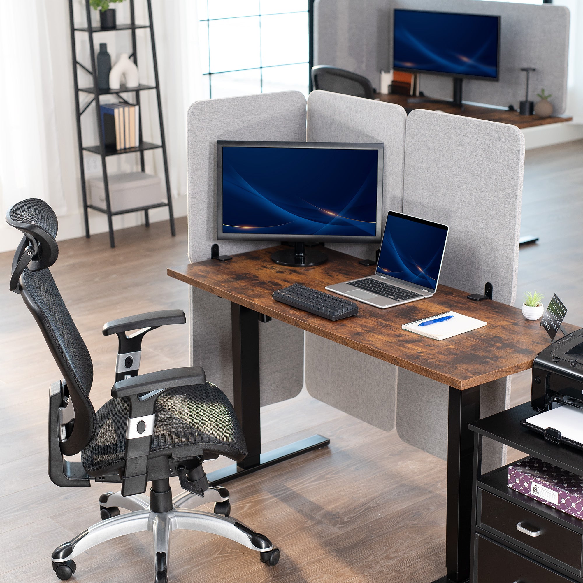 Modern office setup with a desk, chair, accessories, and a clamp-on privacy panel.