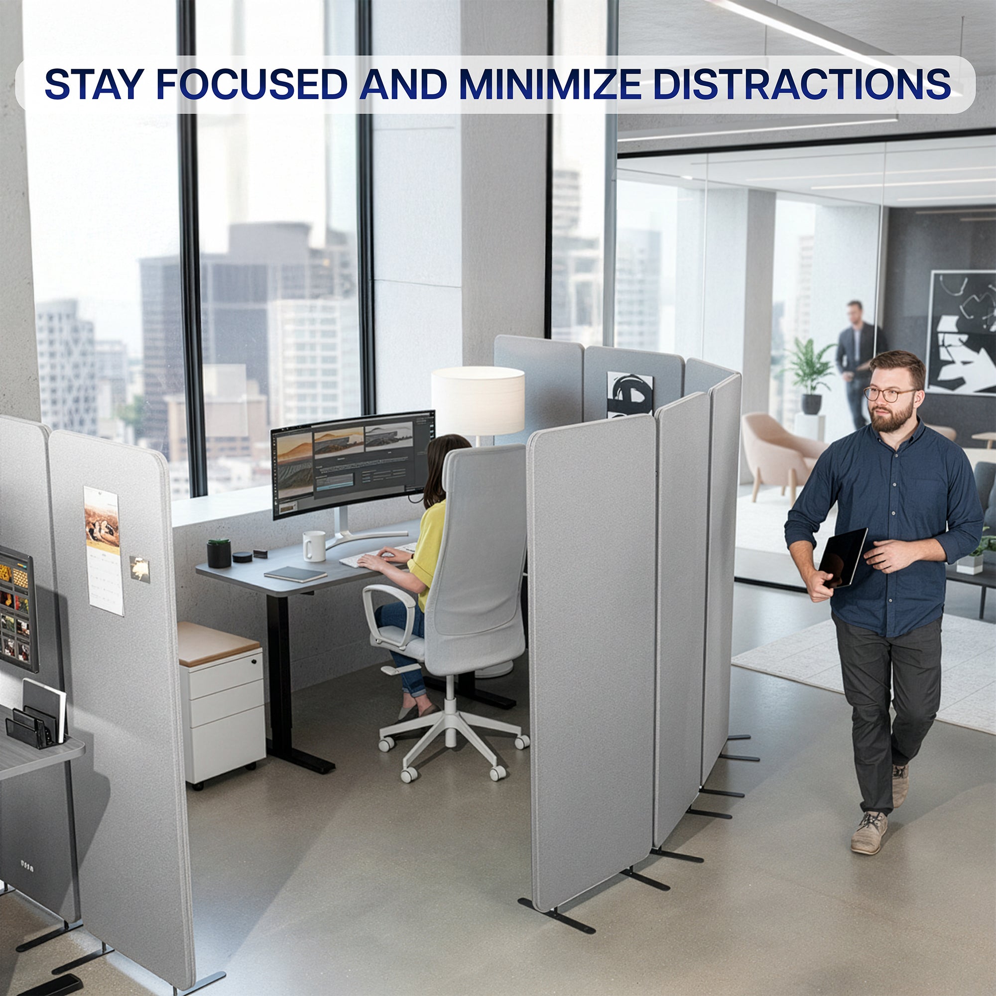 Modern office space with gray freestanding room dividers (x3) with employees working at their desks, featuring text 'Stay focused and minimize distractions'.