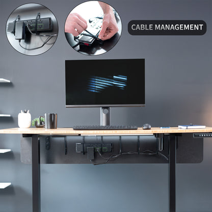 A black laminate modesty panel attached to a wooden desk with a black leg frame with cable management feature highlighted.
