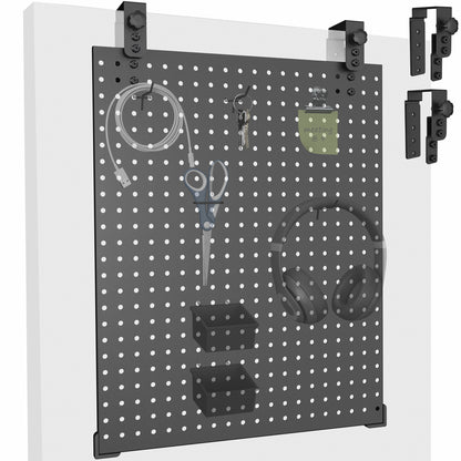 A black pegboard with various tools and equipment hanging on it, mounted on a white wall.