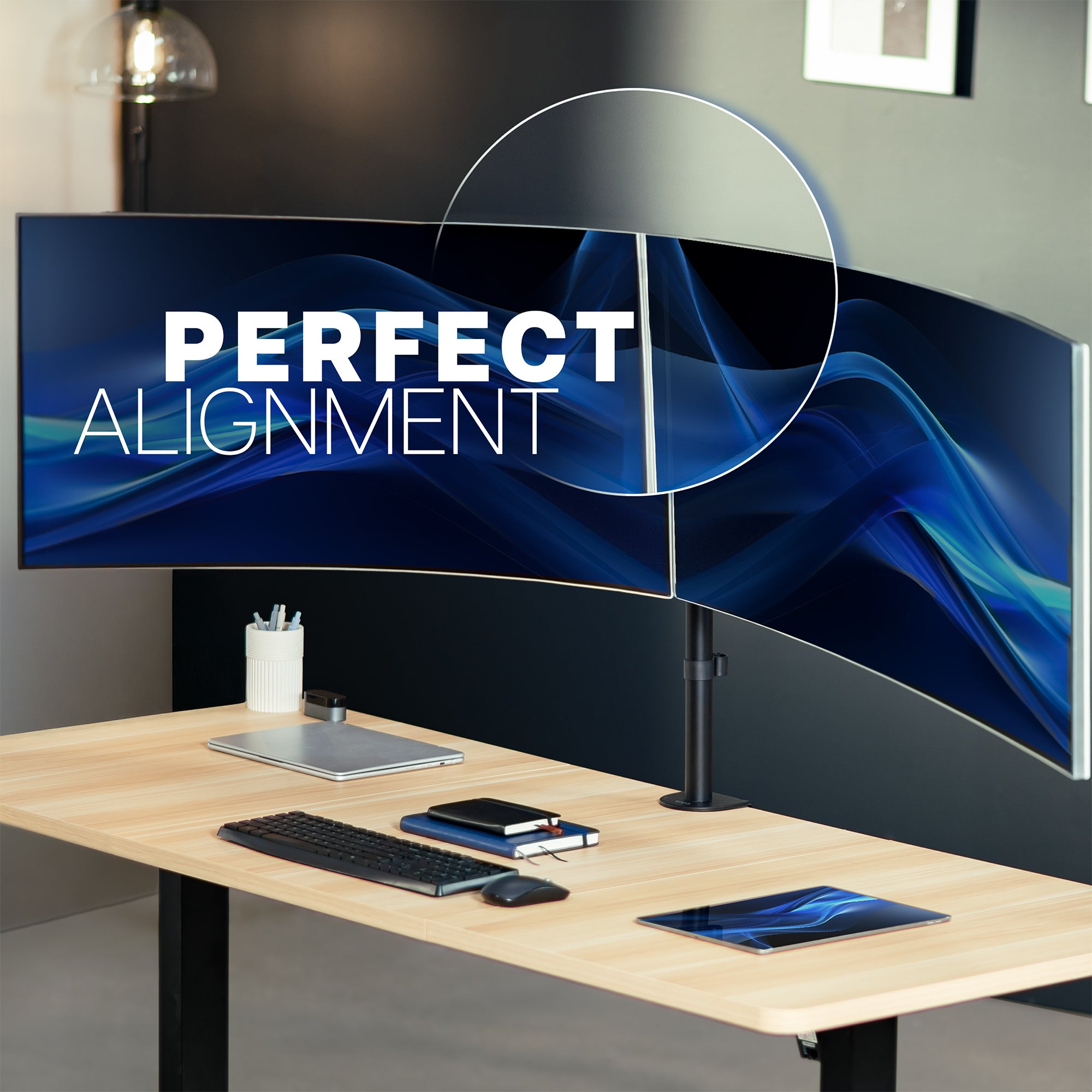 Desk setup with monitors displaying 'PERFECT ALIGNMENT' text in a modern office setting.