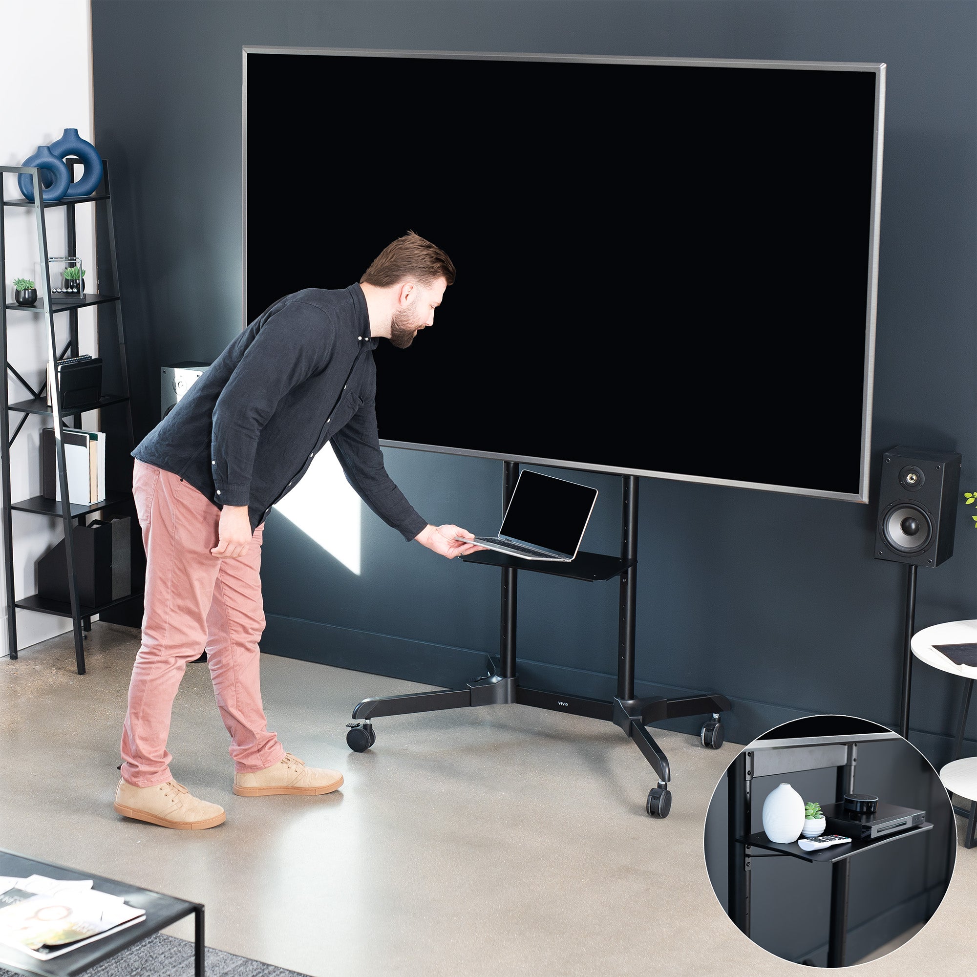 Mobile TV mount cart with media shelf and locking wheels. Stand features height adjustment, articulation, and a built-in cable management system.
