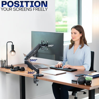 Woman sitting at a desk with a computer setup, featuring a monitor on an adjustable stand.