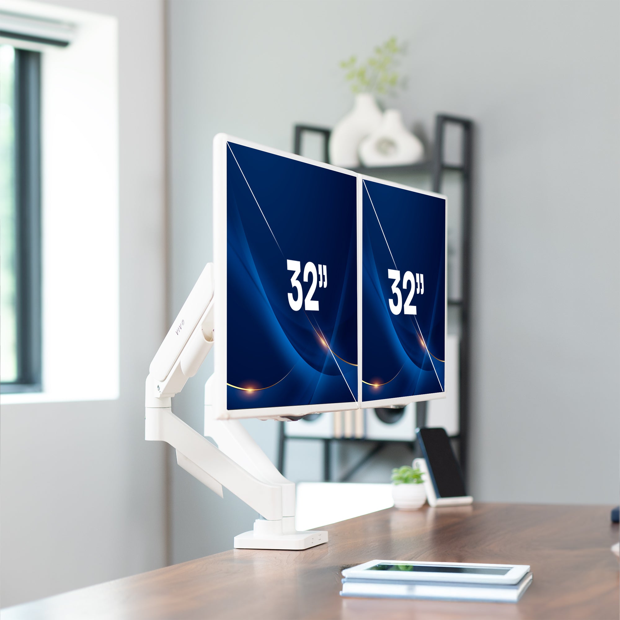 Sturdy adjustable mechanical arm dual monitor ergonomic desk stand in a home office space.