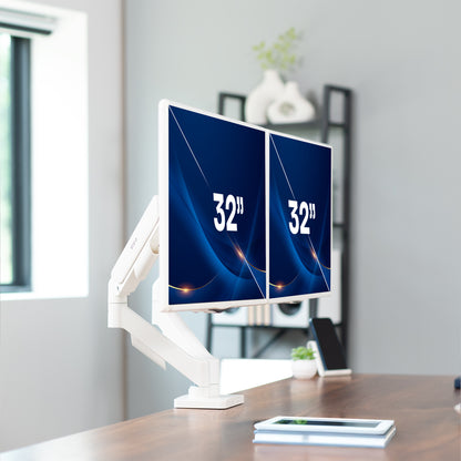 Sturdy adjustable mechanical arm dual monitor ergonomic desk stand in a home office space.