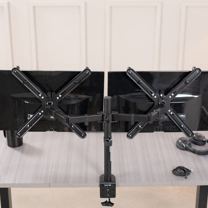 Dual Monitor Desk Mount with VESA Adapter Bracket mounted on desk in office setting.