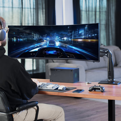 Person playing a racing game on a large monitor in a modern living room.