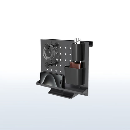 A black pegboard desk organizer with various slots and holders for office supplies and a mobile phone.