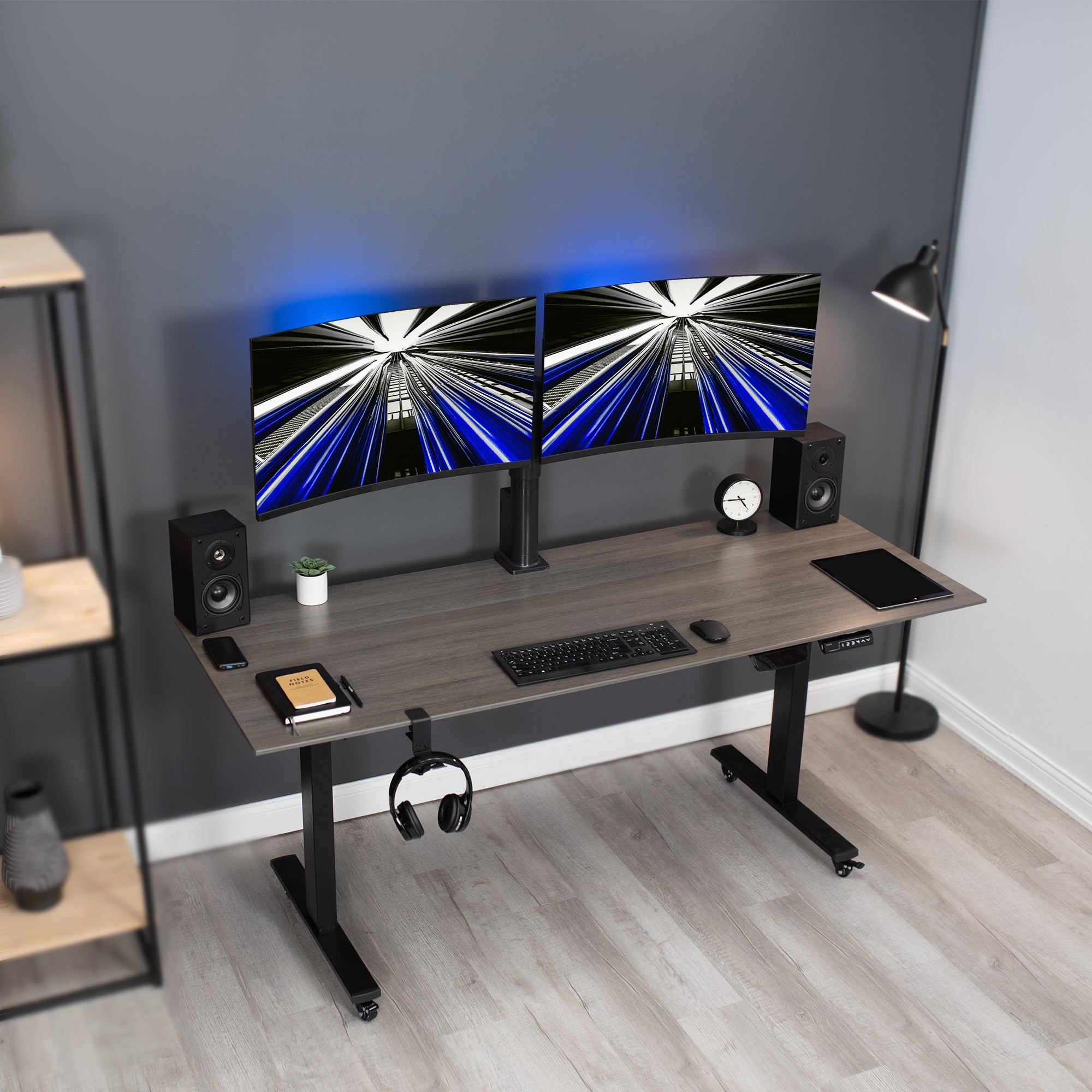 Electric Dual Monitor Arm Mount on desk in home office space. 