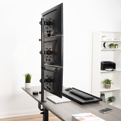 Triple Vertical Monitor Desk Mount on desk in office setting.